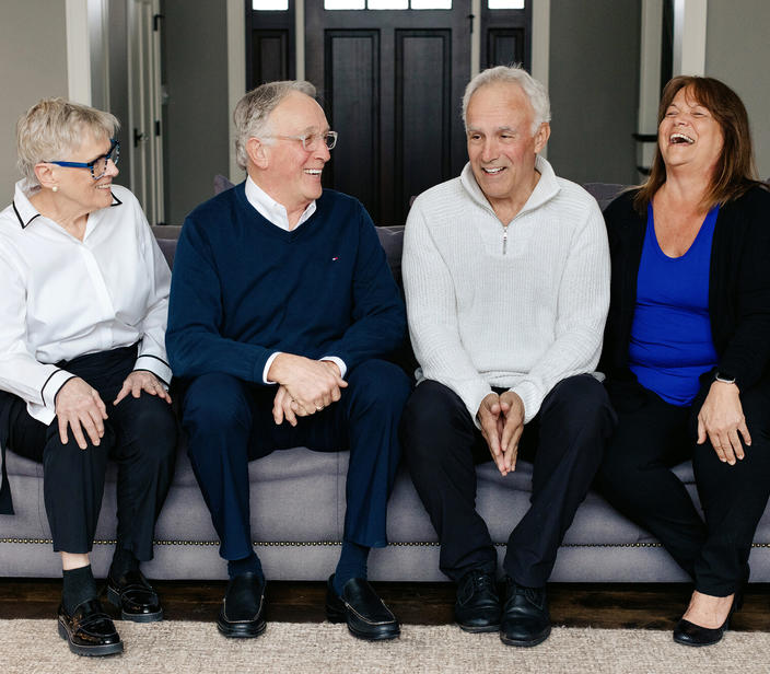 Photograph of four people sitting on a couch.